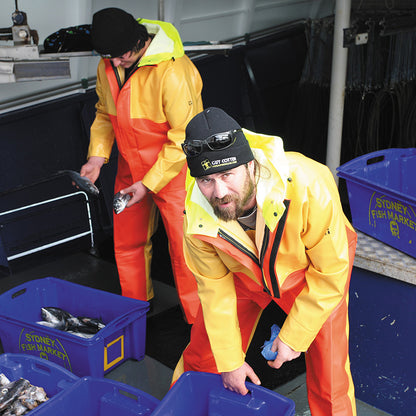 Two people in bright safety jackets with fishing equipment in a storage area.