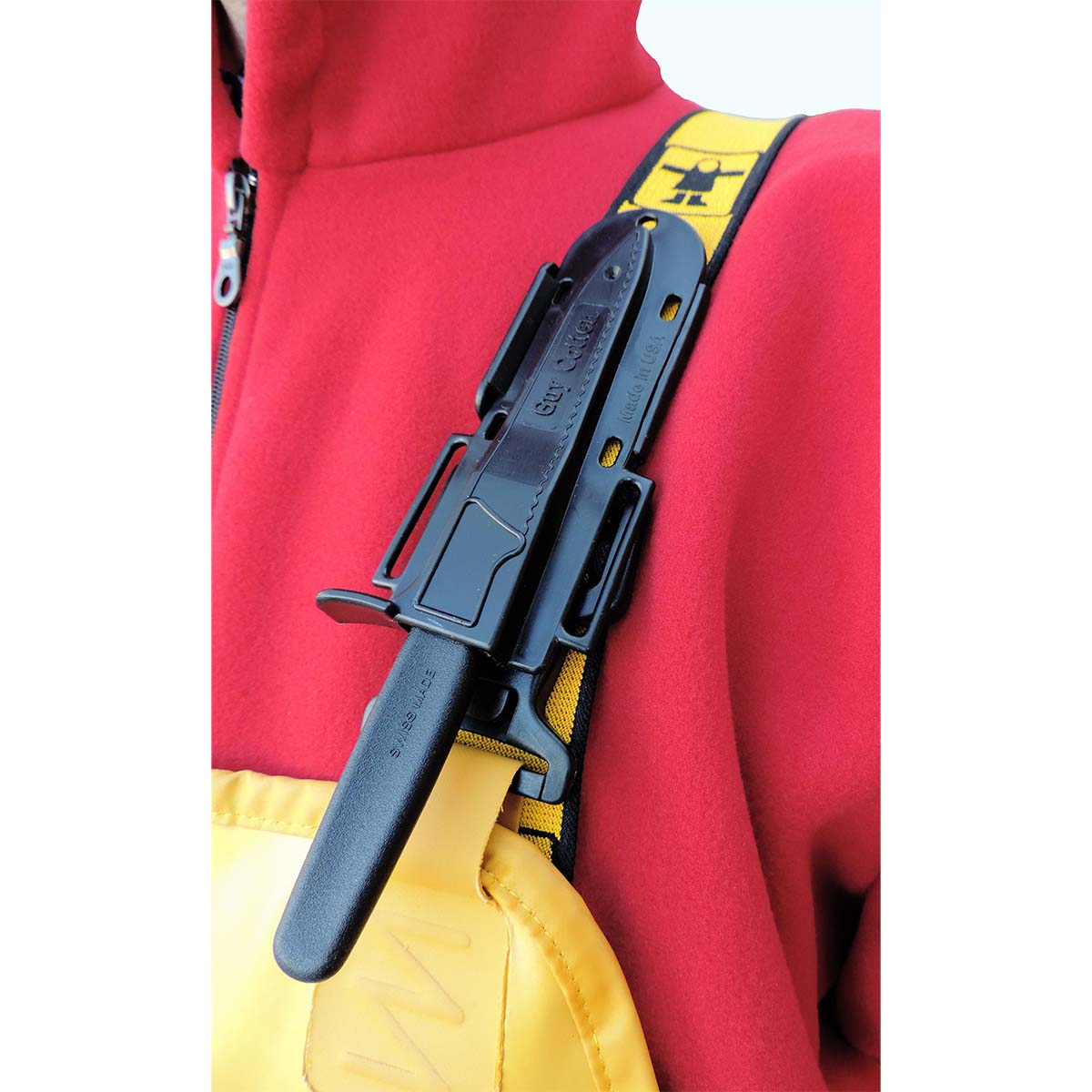 Black knife sheath attached to Guy Cotten fishing bib & braces with a red jacket background, compatible with Victorinox 6.7433 knife